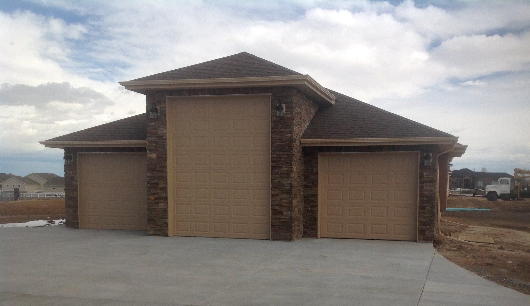 Garag with three garage doors and a driveway .