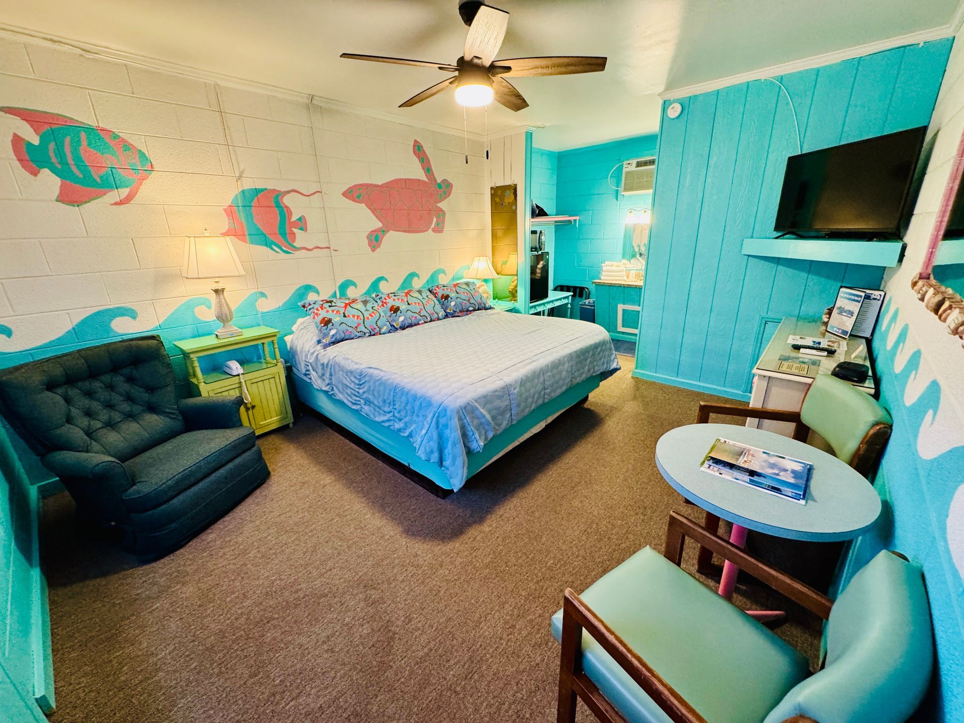 A bedroom with a bed and a painting of a turtle on the wall.
