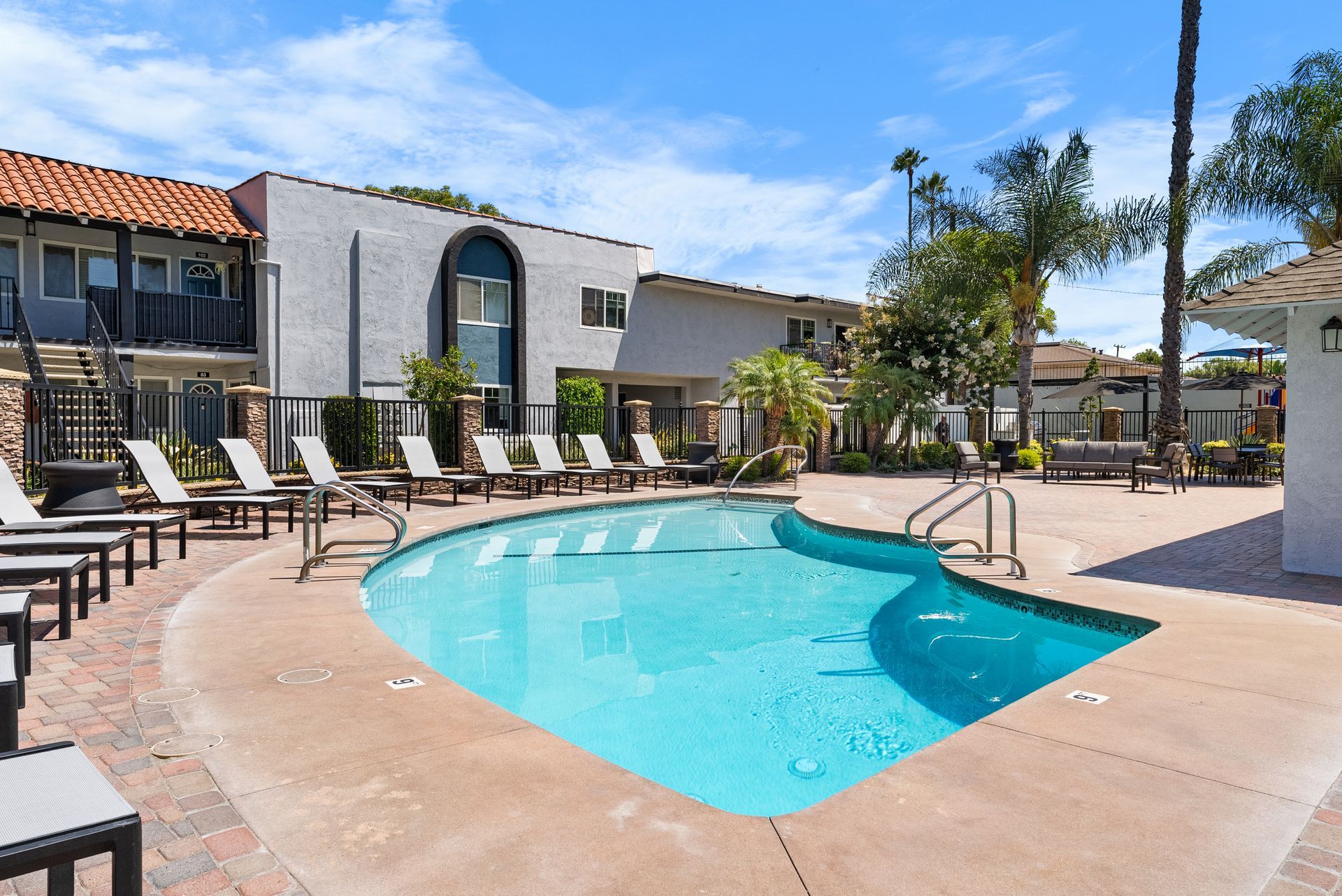 Pool, building exterior, and lounge chairs