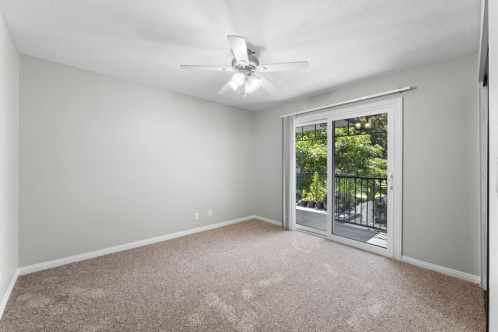 Carpeted bedroom with patio door