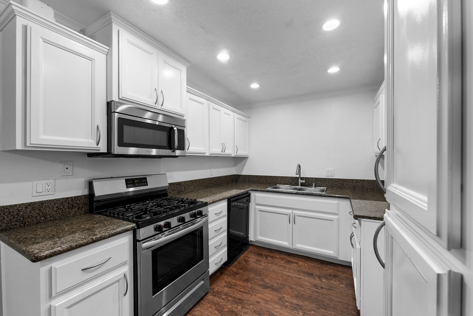 Kitchen with stove, microwave, and sink