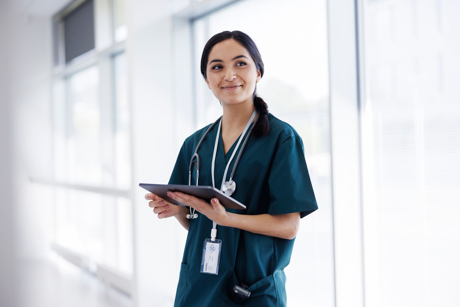 Female doctor in hospital looking at digital tablet Female doctor in hospital looking at digital tablet
