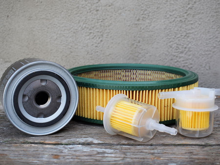 A group of fuel filters are sitting on a wooden table.