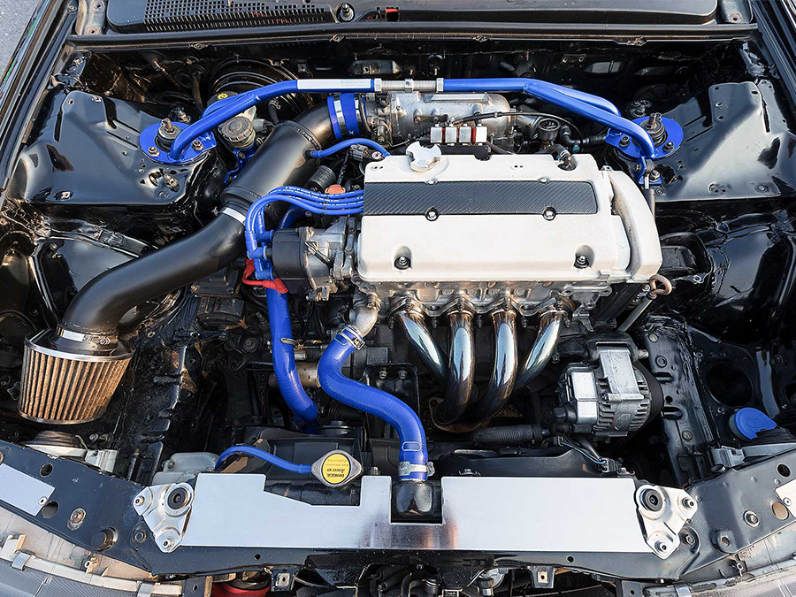 A car engine with blue hoses coming out of it