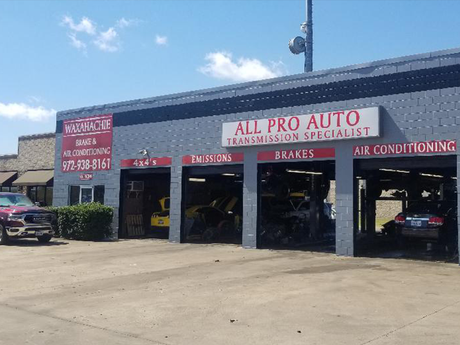 A car is parked in front of an all pro auto transmission specialist