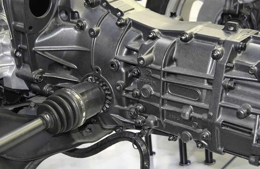 Gray automobile transmission with attached axle.