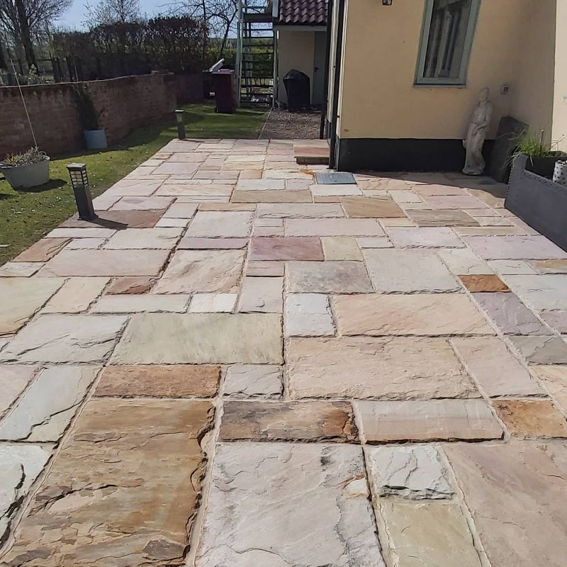 A stone walkway in front of a house