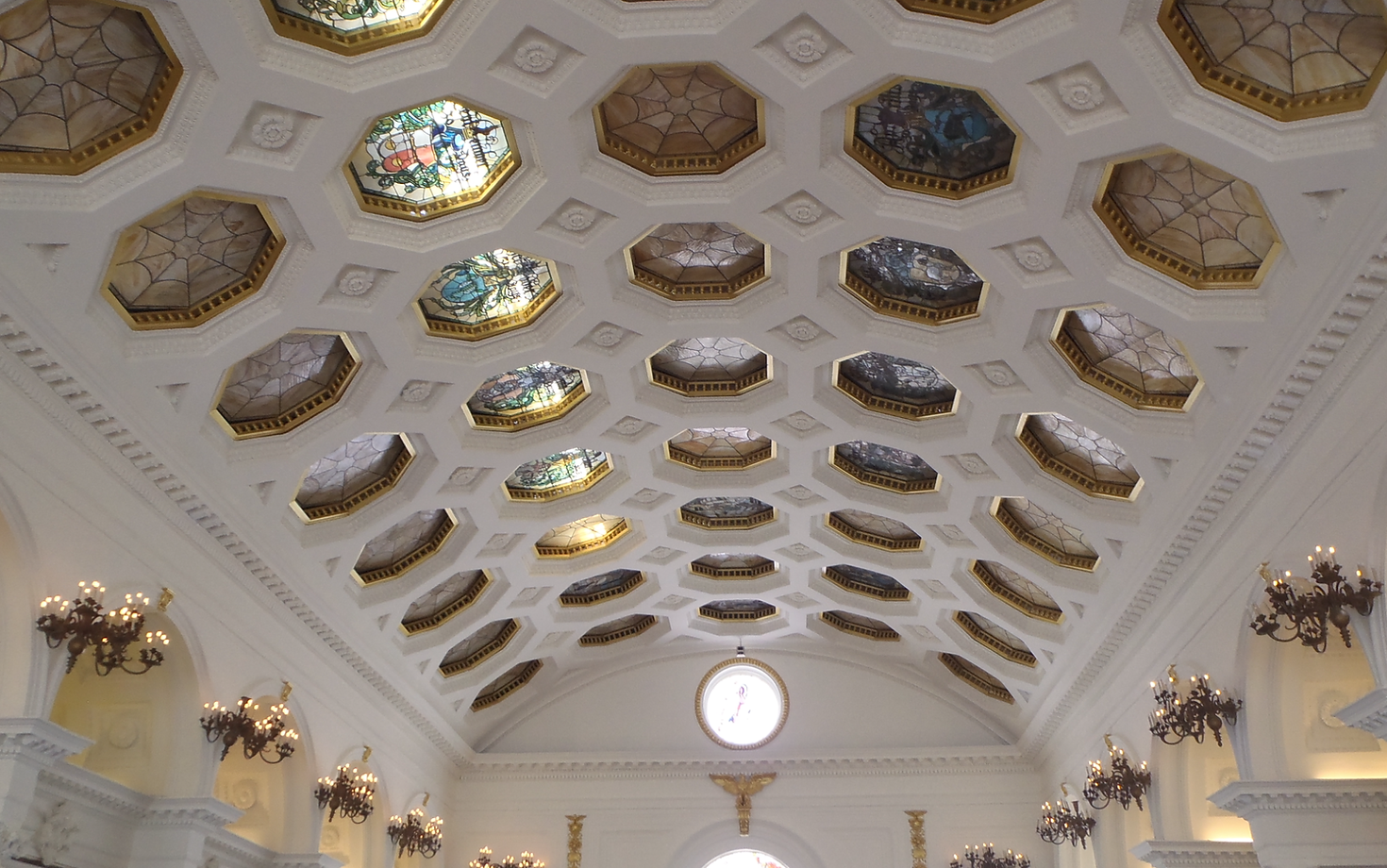 The inside of a building with a clock on the ceiling