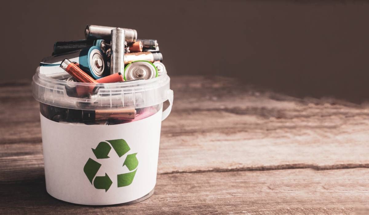 A variety of household alkaline batteries in a recycling bucket near Lexington, KY