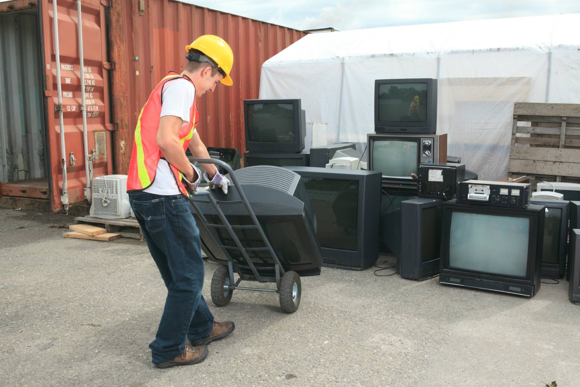 A worker loading old TVs for disposal near Lexington, Kentucky (KY)