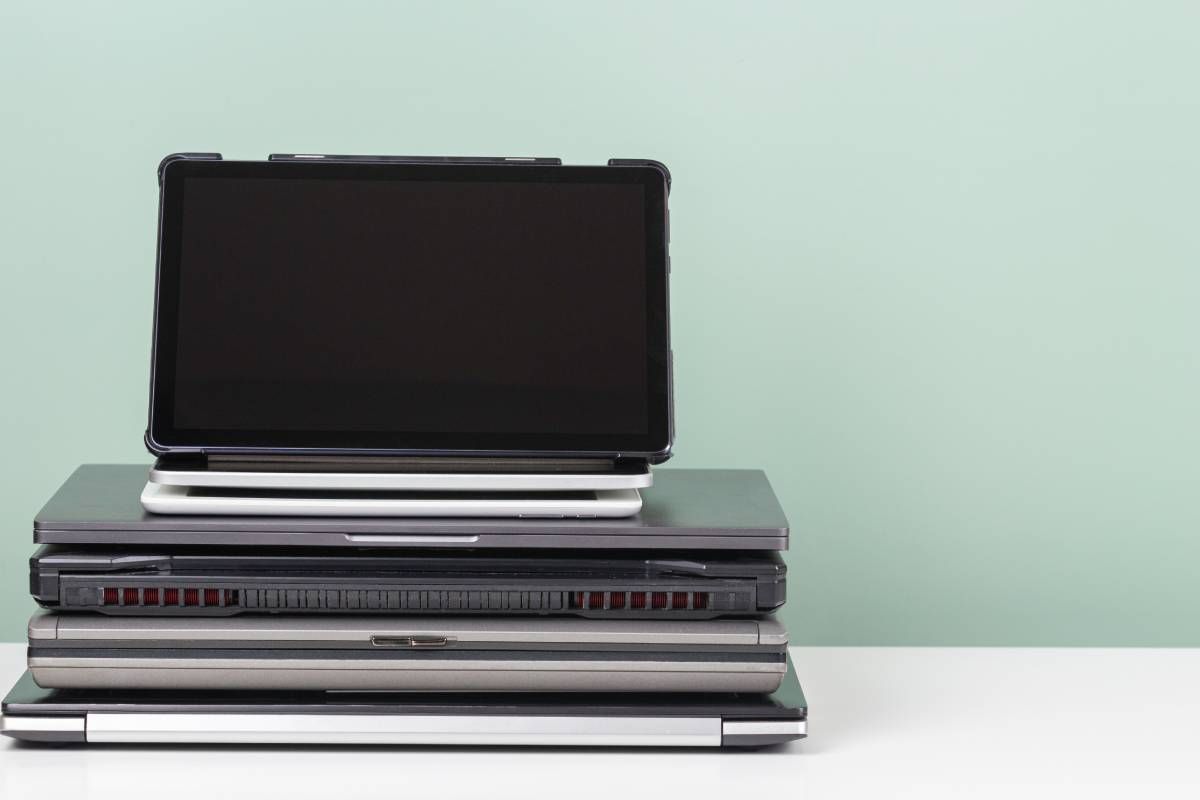 Pile of old used laptop on white table for recycling near Lexington, Kentucky (KY)