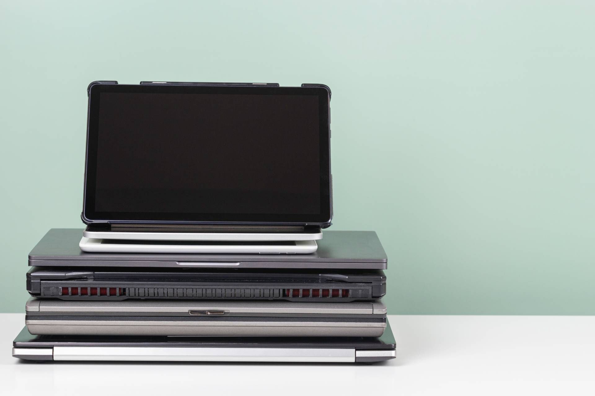 Pile of old used laptop on white table for recycling near Lexington, Kentucky (KY)