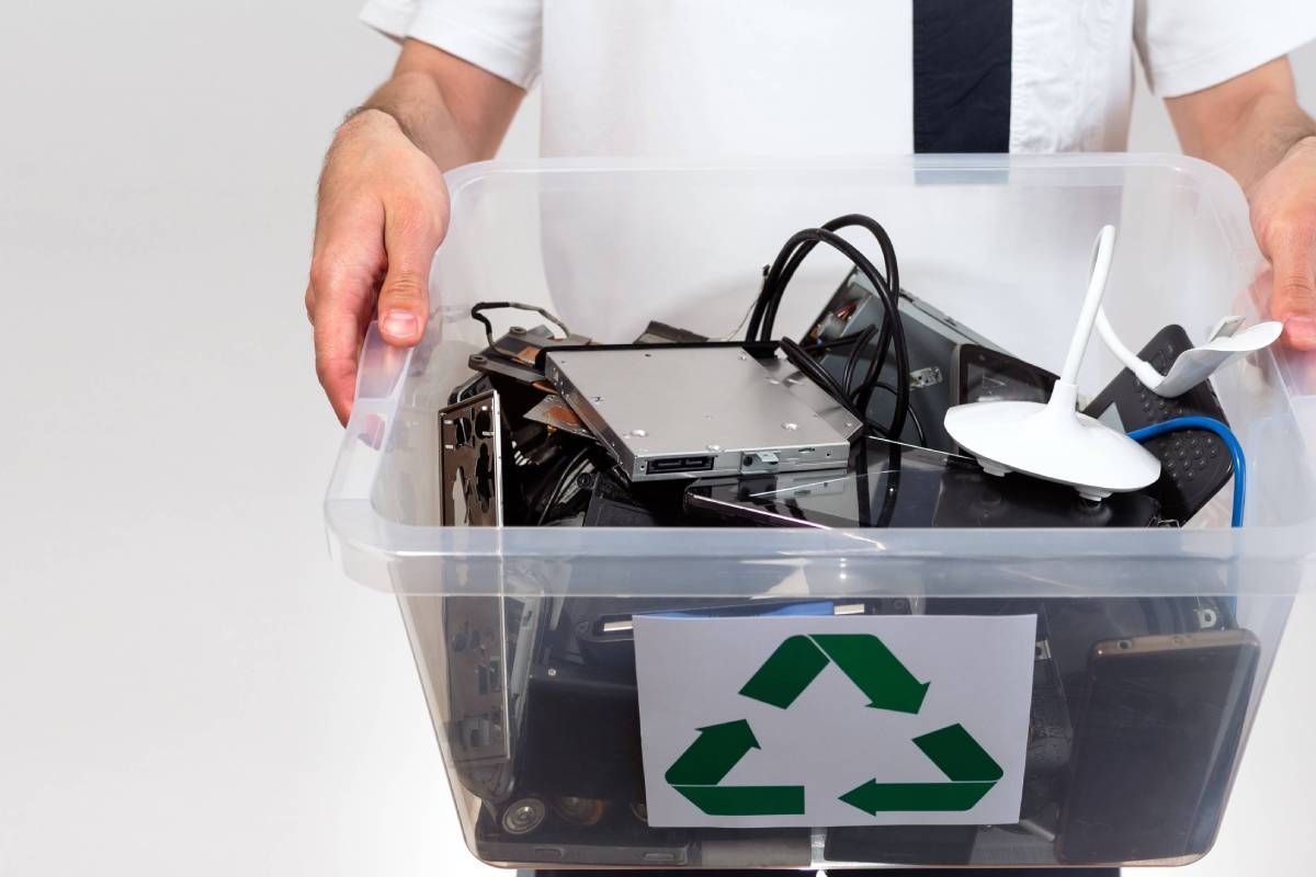 A person carrying a container or electronics for disposal near Lexington, Kentucky (KY)