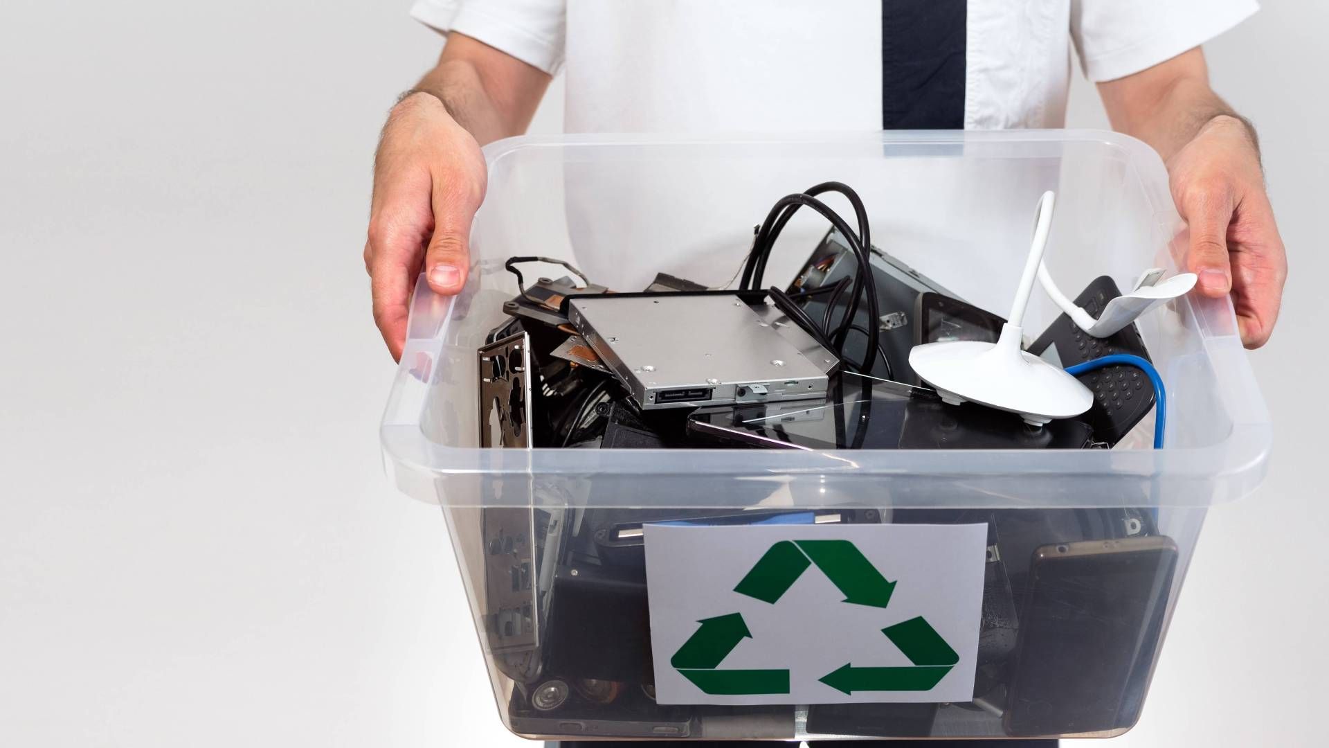 A person carrying a container or electronics for disposal near Lexington, Kentucky (KY)