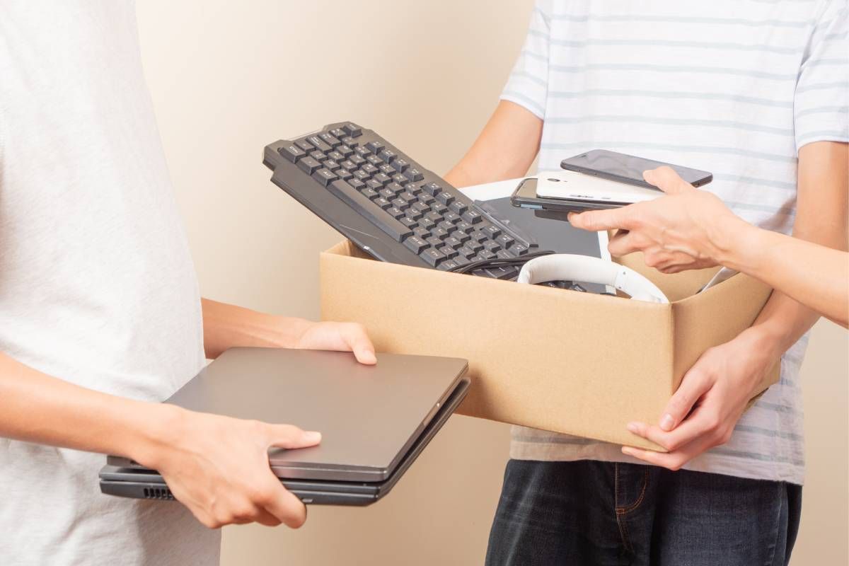 Clients bringing cardboard boxes with keyboards and laptops to a recycling drop off near Lexington, Kentucky (KY)