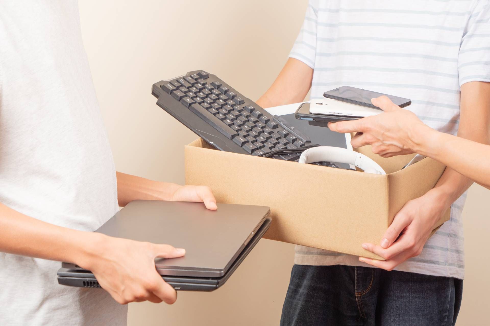 Clients bringing cardboard boxes with keyboards and laptops to a recycling drop off near Lexington, 