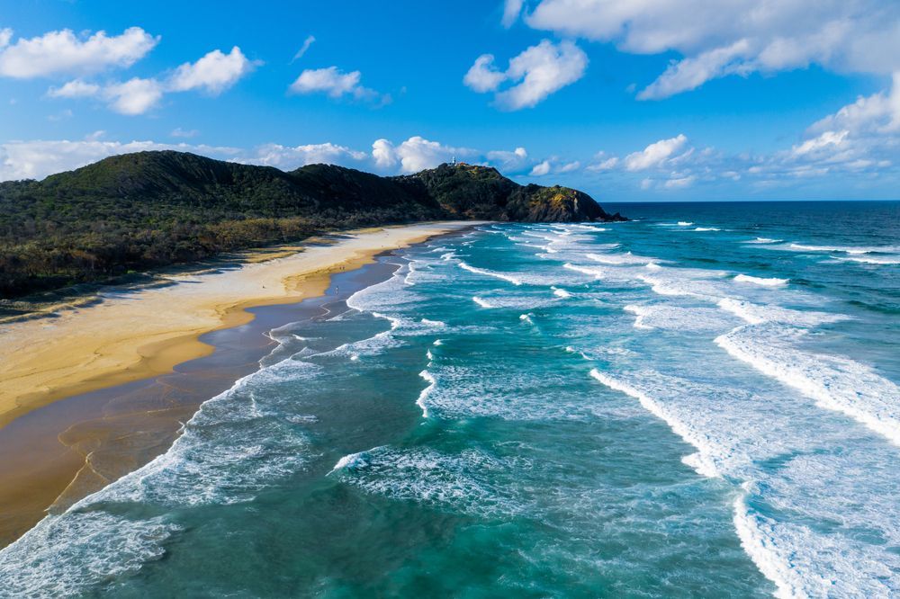 An Aerial View of a Beach With Mountains in the Background — Lighthouse Pest Control In Suffolk Park, NSW