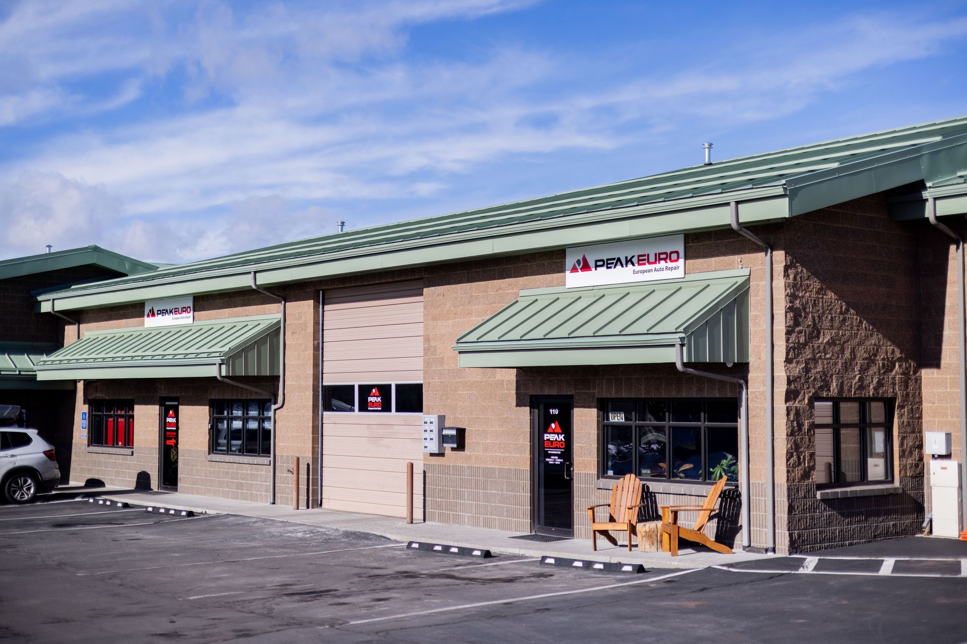 Brick building with green roof, signs reading 