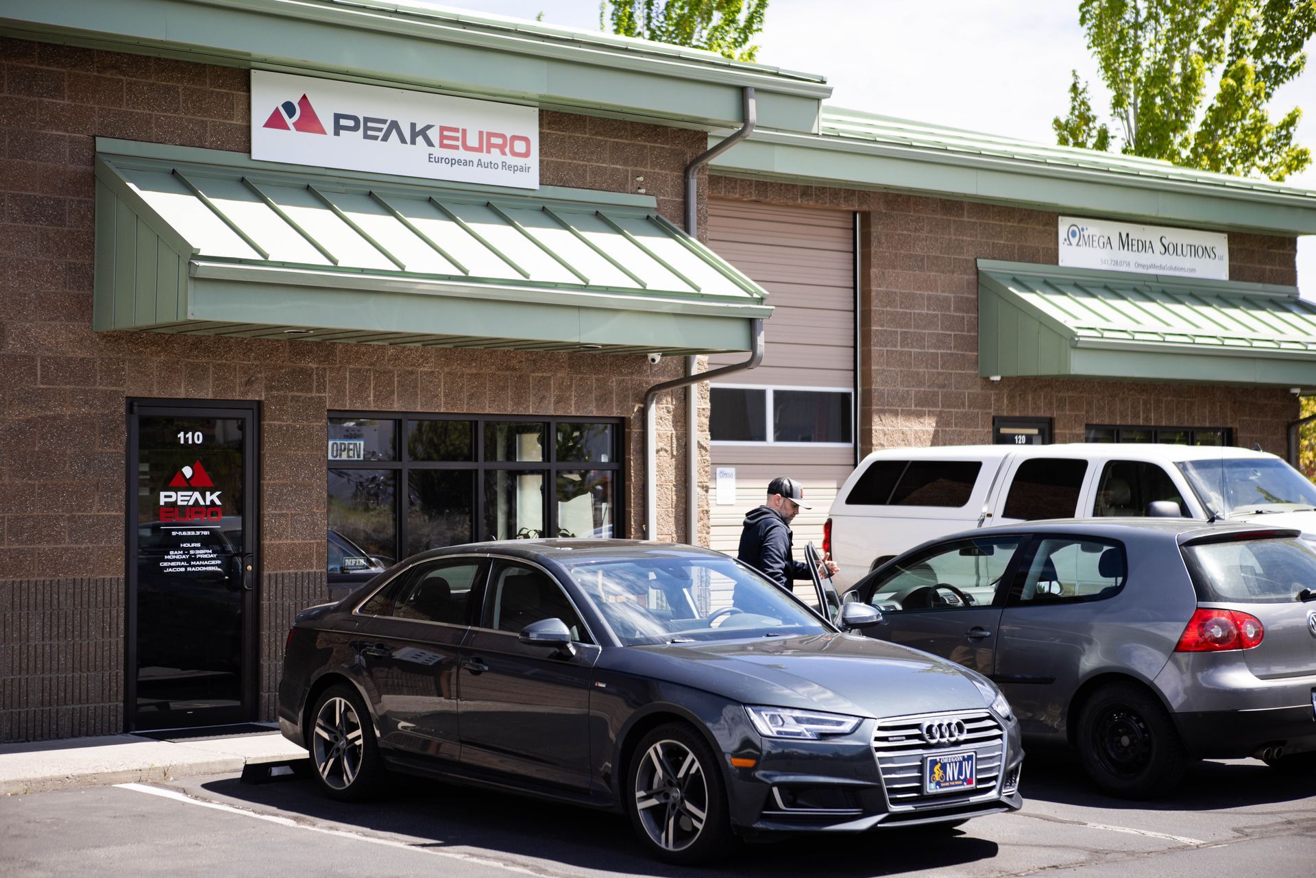 Exterior of Peak Euro auto shop with a car and person outside. | Peak Euro