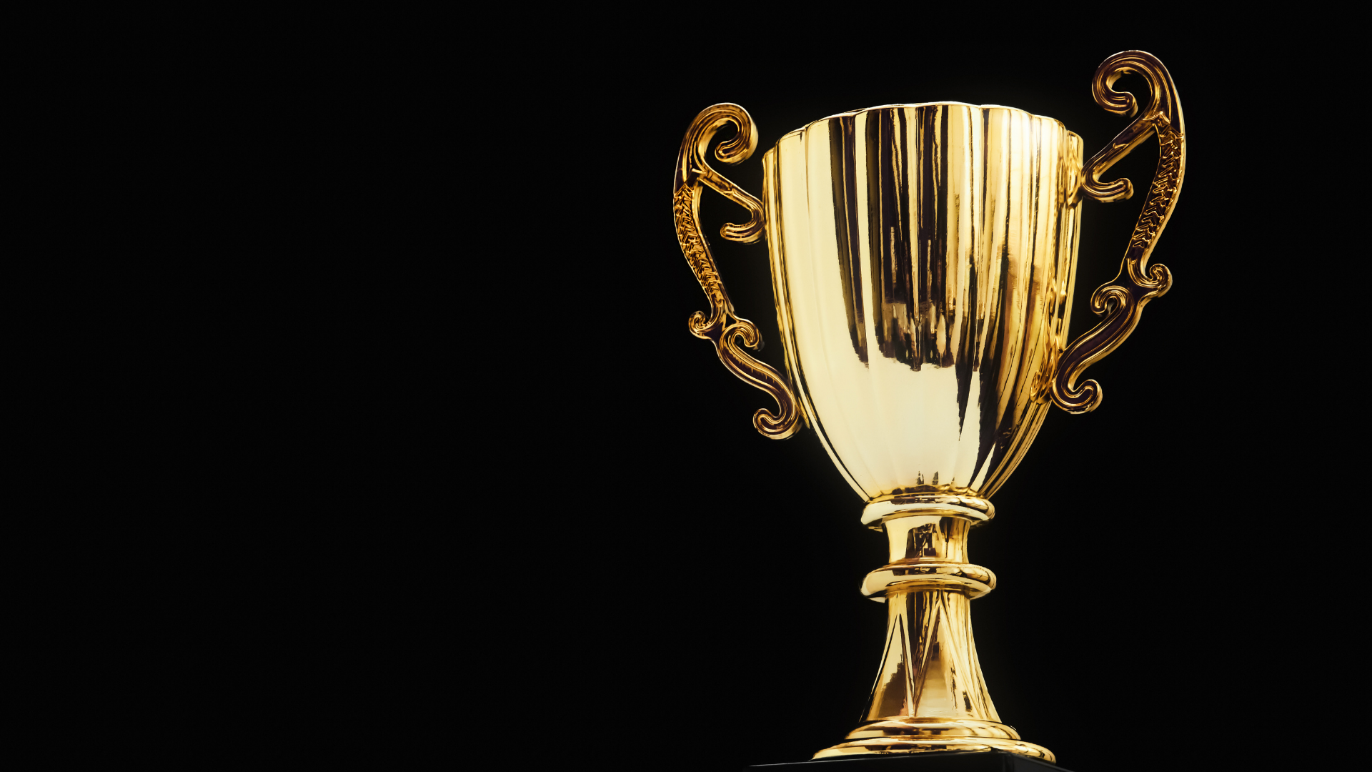 A silver trophy is sitting on top of a white table.