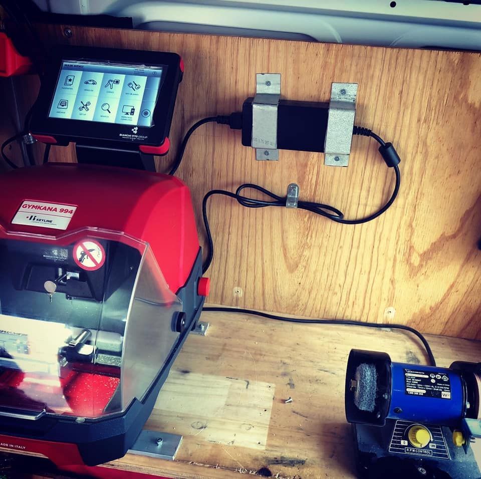 A Key Machine Is Sitting on A Wooden Table — Toowoomba Locksmiths in Dalby, QLD