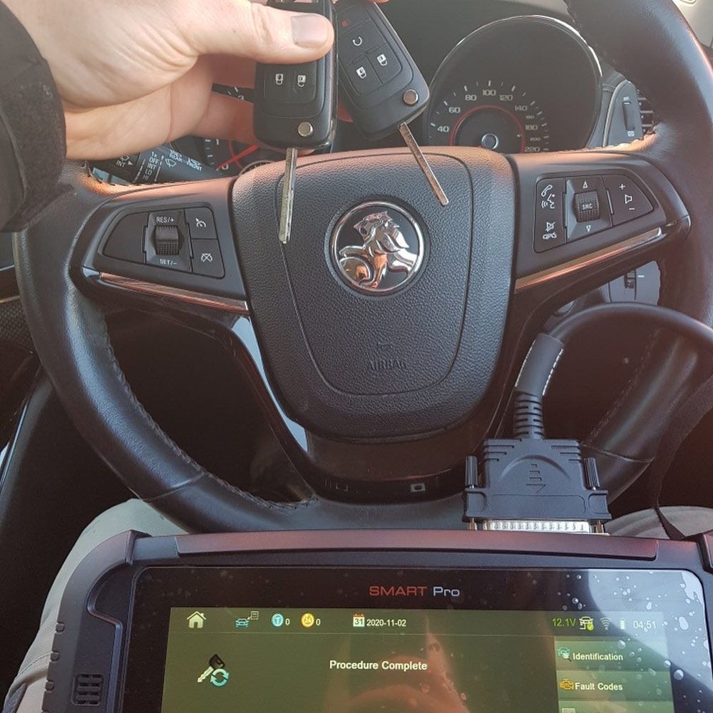 A Person Is Holding a Car Key — Toowoomba Locksmiths in Toowoomba City, QLD