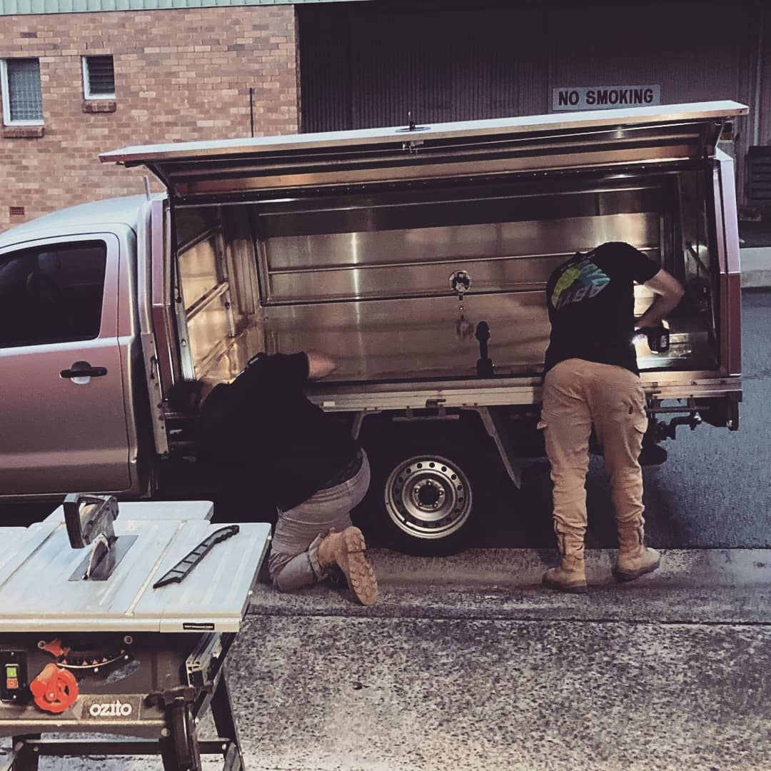 A Man Is Working in A Car — Toowoomba Locksmiths in Gatton, QLD