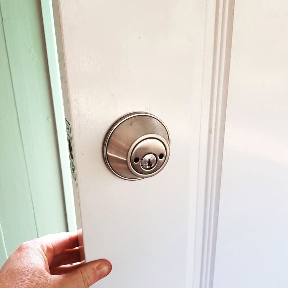 A Person Is Opening a Door — Toowoomba Locksmiths in Toowoomba City, QLD