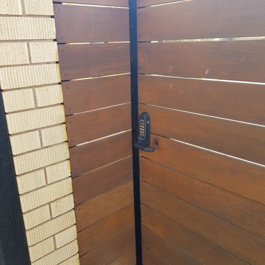 A Wooden Gate with A Brick Wall — Toowoomba Locksmiths in Highfields, QLD