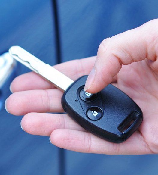 A Person Is Holding a Car Key — Toowoomba Locksmiths in Toowoomba City, QLD