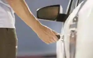 Man Is Opening the Door of A White Car — Toowoomba Locksmiths in Toowoomba City, QLD