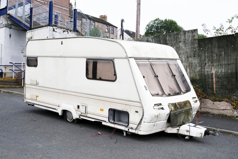 A White Caravan Is Parked On The Side Of The Road — Great Lakes Caravans In Forster, NSW