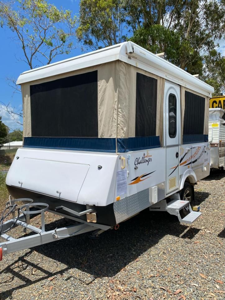A White Camper Trailer Is Parked In A Gravel Lot — Great Lakes Caravans In Forster, NSW