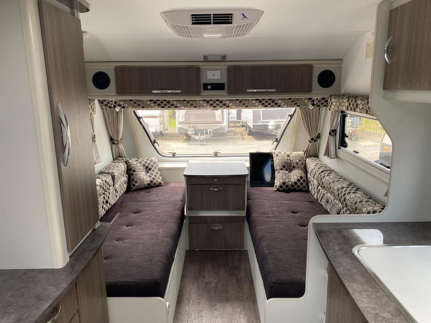 The Inside Of A Camper With Two Beds And A Kitchen — Great Lakes Caravans In Forster, NSW