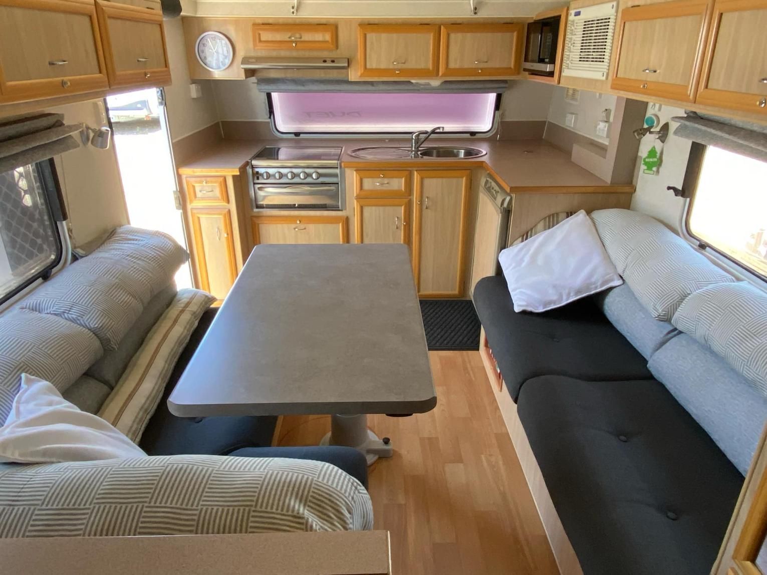 A Kitchen With A Table And A Couch In It — Great Lakes Caravans In Forster, NSW