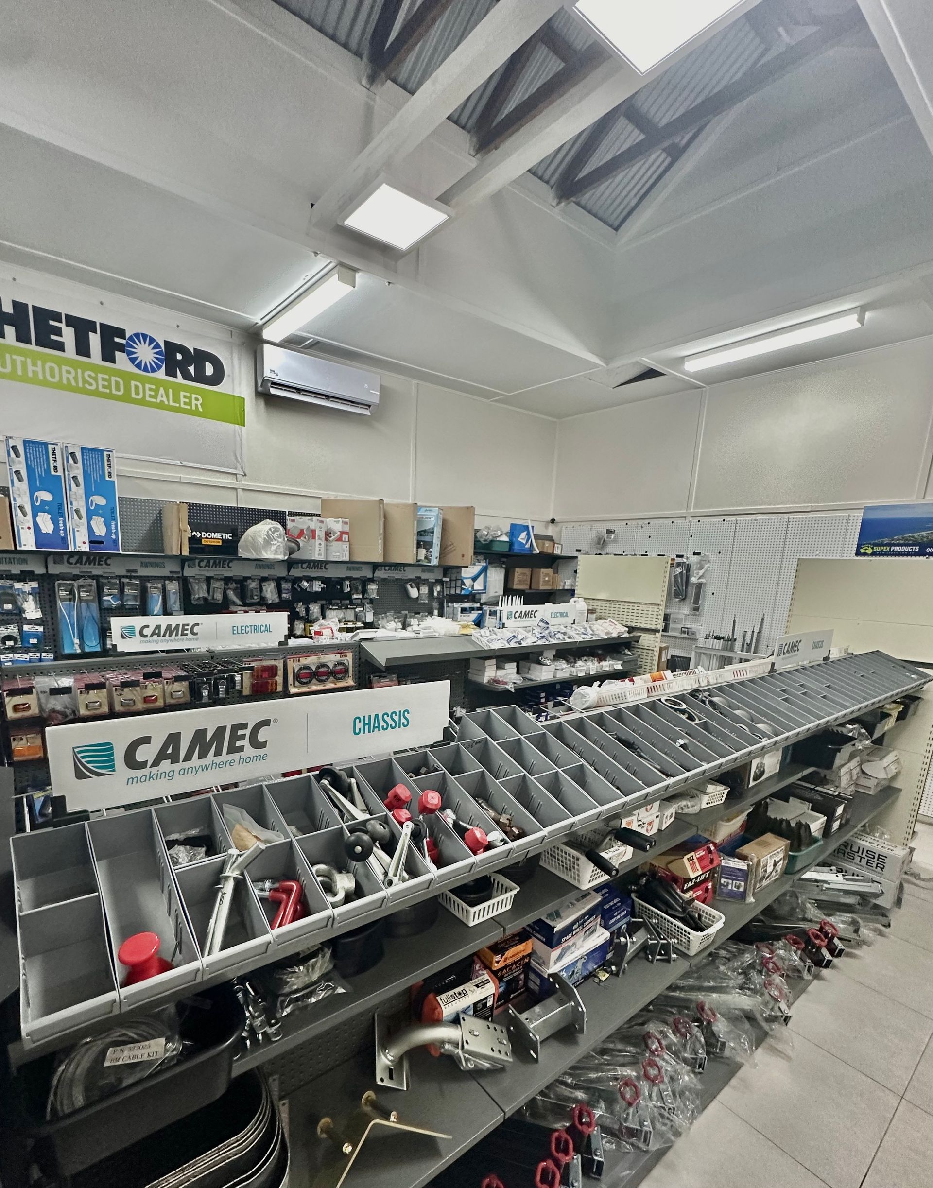 A store filled with lots of shelves and a camec sign — Great Lakes Caravans In Nabiac, NSW