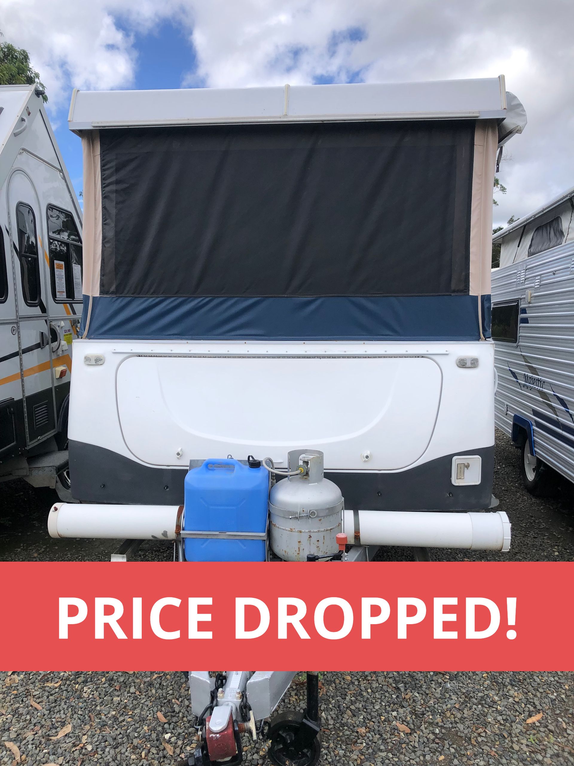 WIND UP CAMPER PARKED ON GRAVEL AT GREAT LAKES CARAVANS