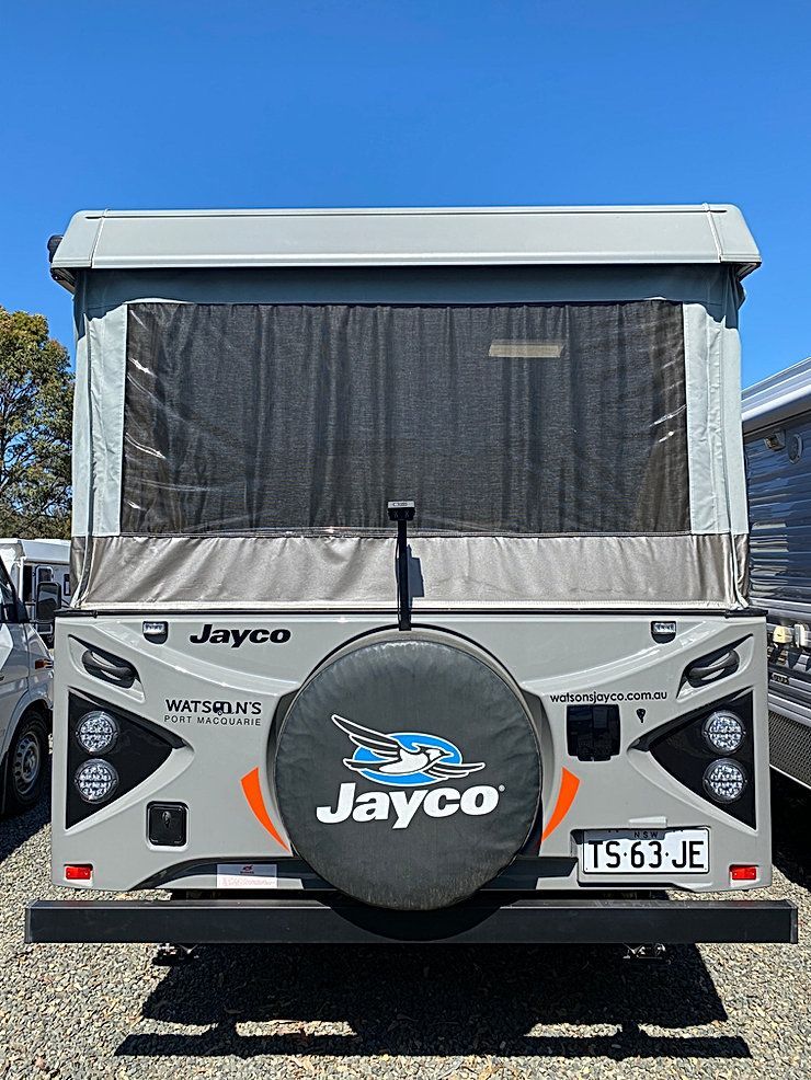 The Back Of A Jayco Camper Van Is Parked In A Gravel Lot — Great Lakes Caravans In Nabiac, NSW