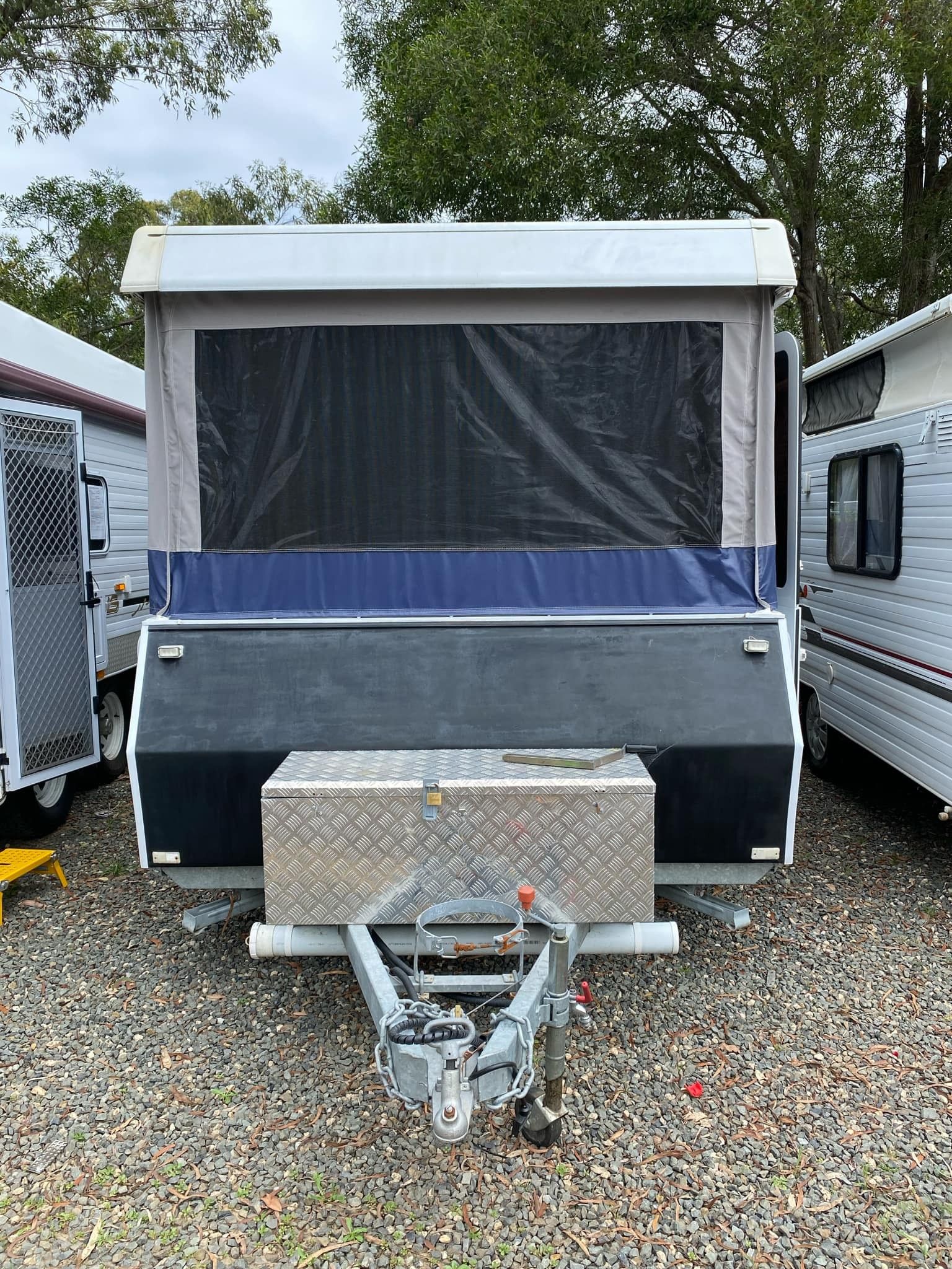 WIND UP CAMPER PARKED ON GRAVEL AT GREAT LAKES CARAVANS