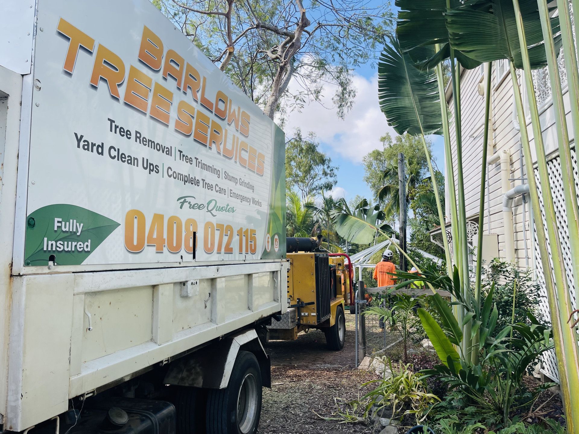 Workers Use Heavy Machinery to Clear Fallen Branches — Barlows Tree Services in Rockhampton, QLD