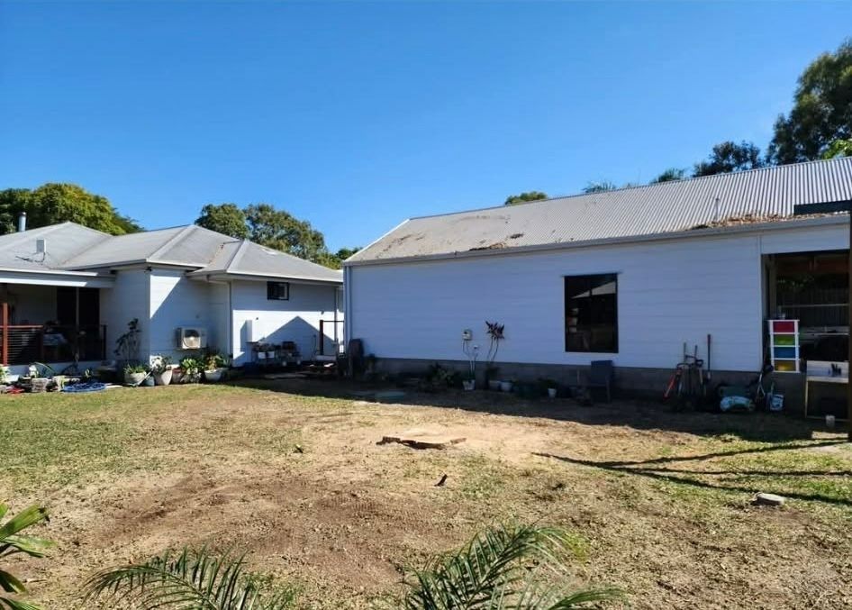 Two White Buildings in a Sunny Yard — Barlows Tree Services in Rockhampton, QLD