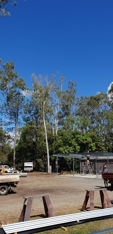 Rural Dirt Lot With Parked Vehicles, Trees — Barlows Tree Services in Rockhampton, QLD