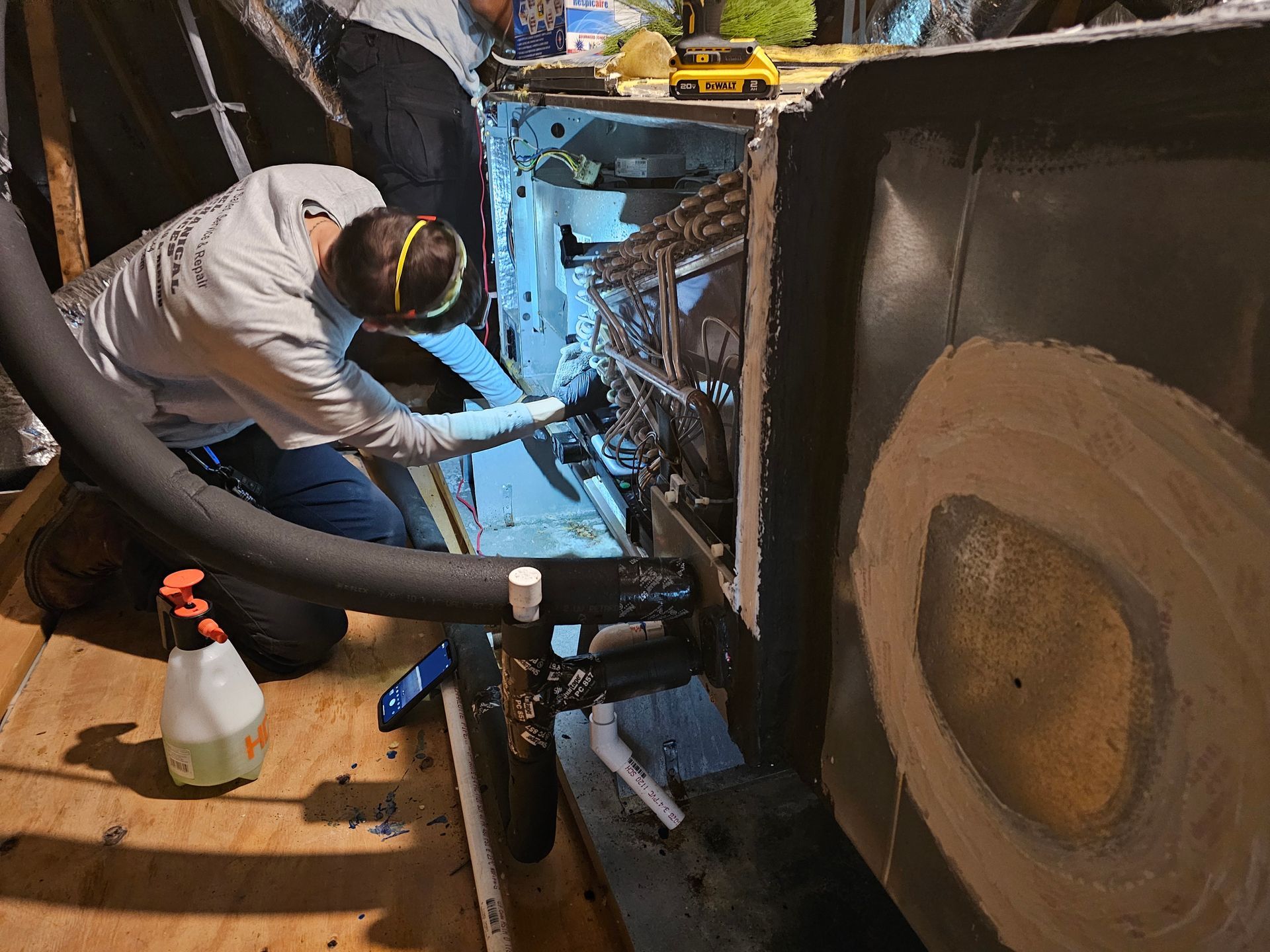 A man is working on a machine with a hose attached to it.