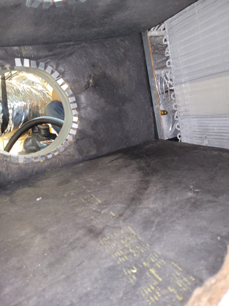 A room with a steering wheel in it and a mirror on the wall.