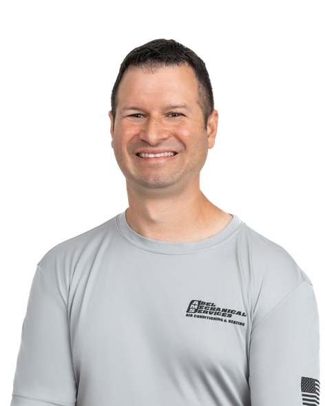 A young man wearing a gray t-shirt is smiling for the camera.