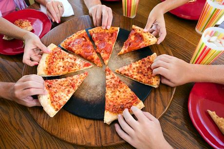Hands taking slices of pizza - Pizza Restaurant in Philadelphia, PA