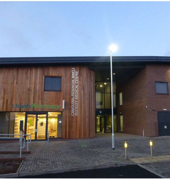 Exterior of Lloyd's Pharmacy and Canolfan Feddygol Rhyd-y-Carw Medical Centre, modern building with wood facade.