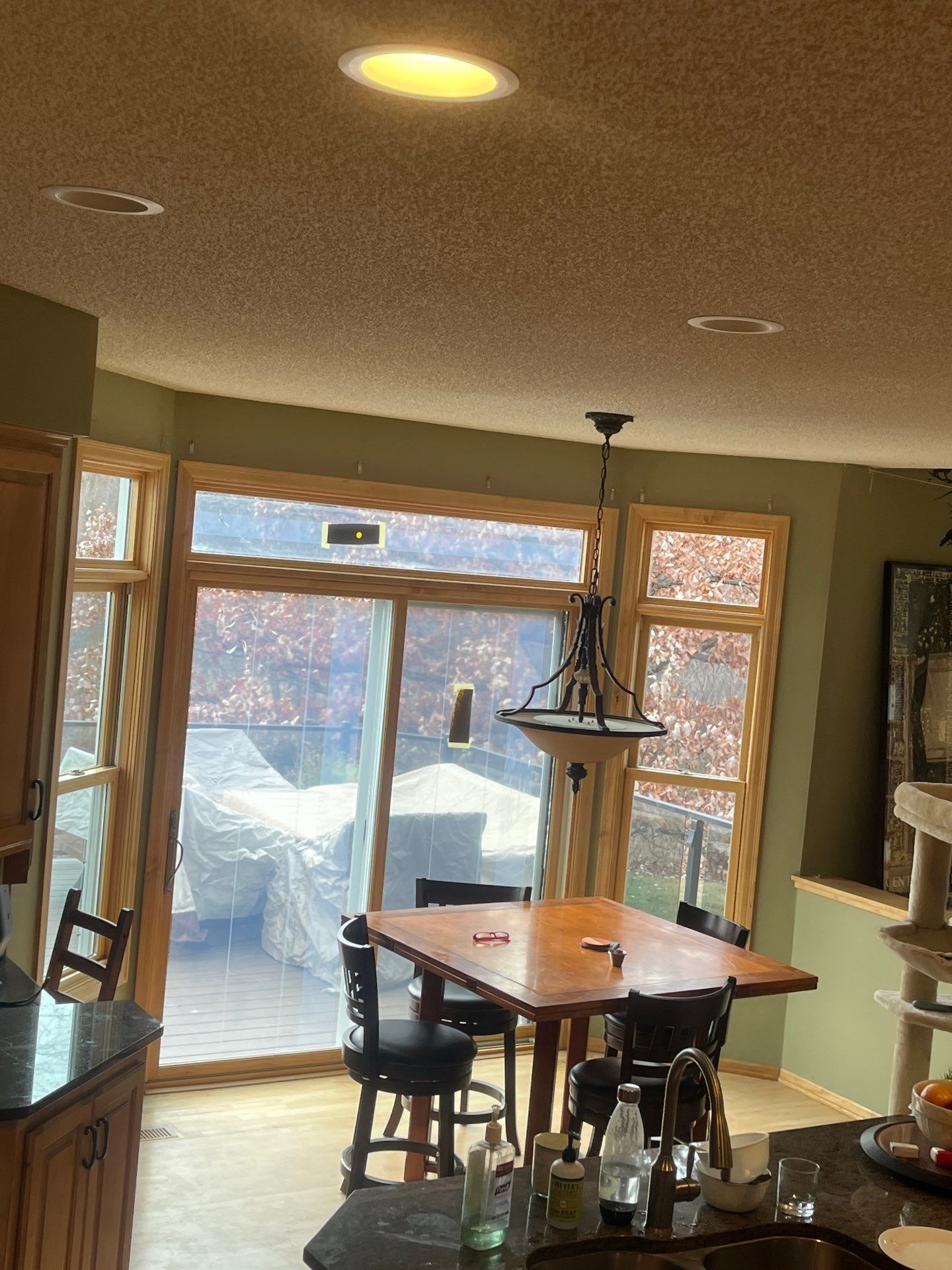 Kitchen with a dining table, sliding door to a deck, and recessed ceiling lights.