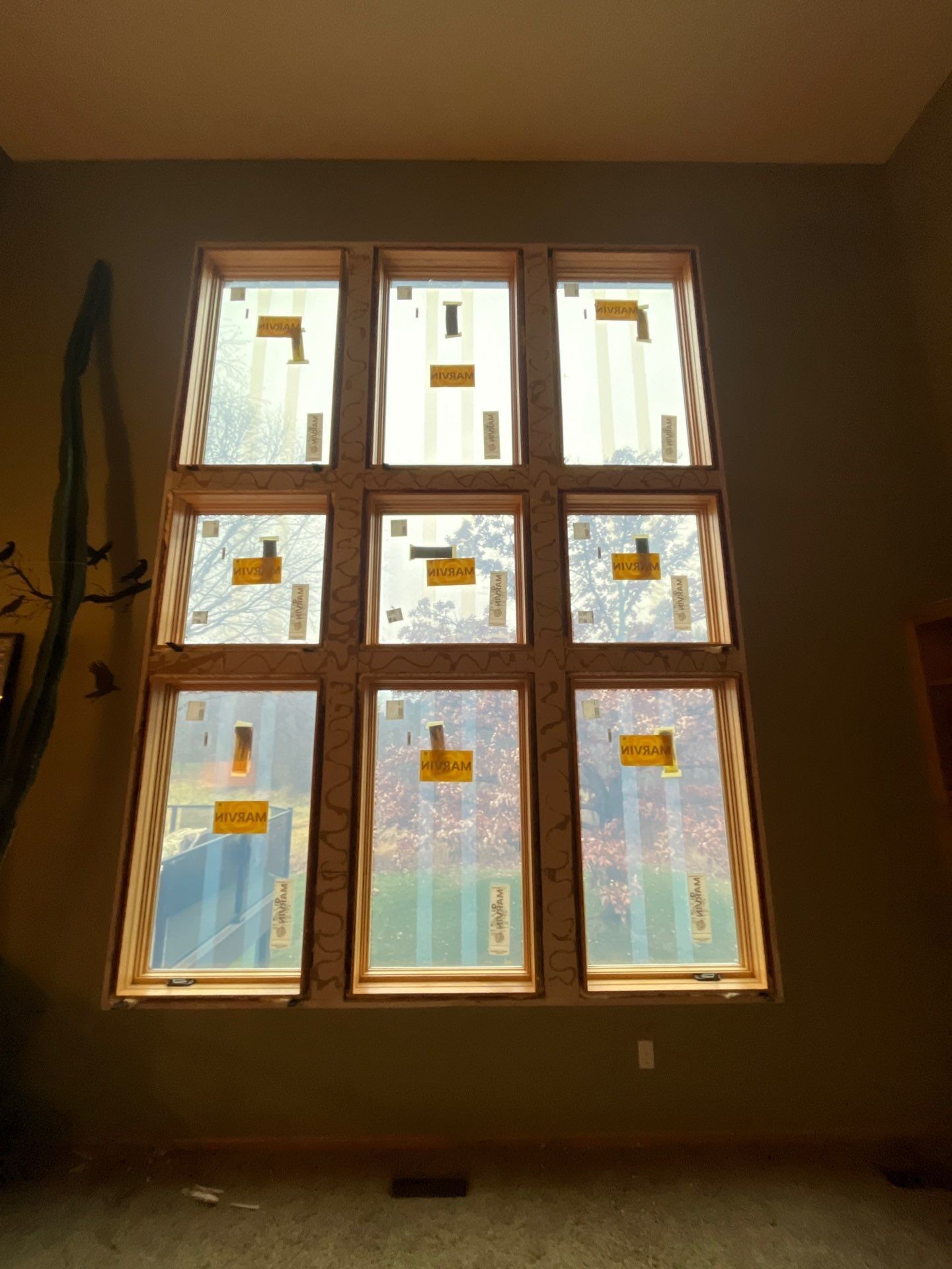 Nine new windows installed in a wall; light streams through the glass.
