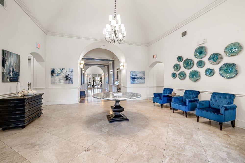 High ceiling clubhouse with a table and chairs at Marquis at The Cascades in Tyler, TX.